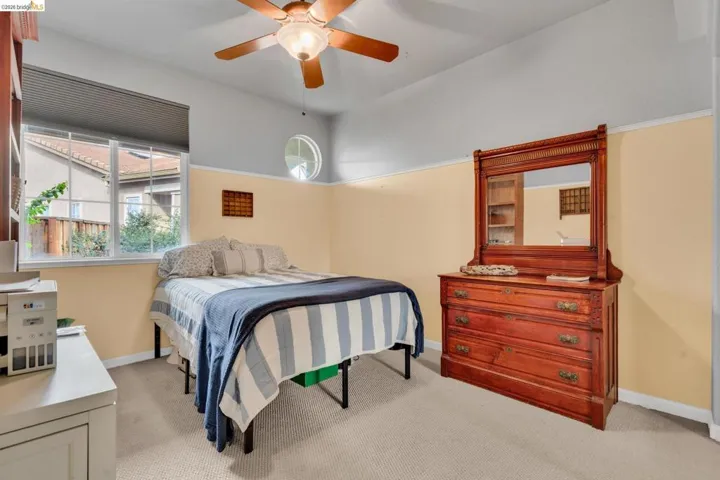 Bedroom with light carpet and ceiling fan