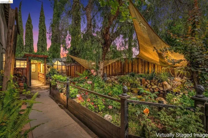 Fenced backyard featuring a garden