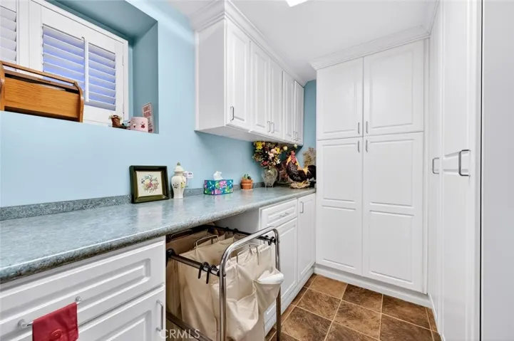 Laundry room with ample storage.