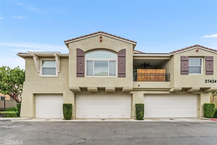 Great curb appeal. Three unit building with subject unit entry on the left. This home extends the entire width of this building over the garages.