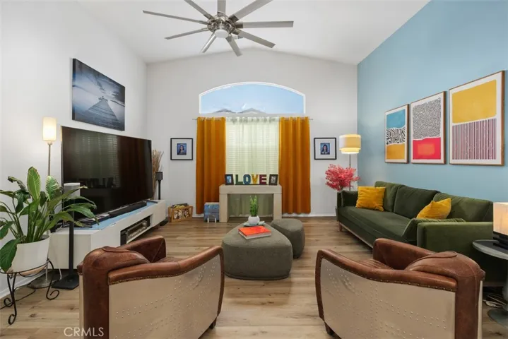Grand living room with vinyl floors and ceiling fan.
