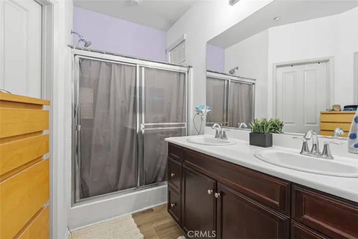The master bath has a dual sink vanity, shower and walk-in closet.