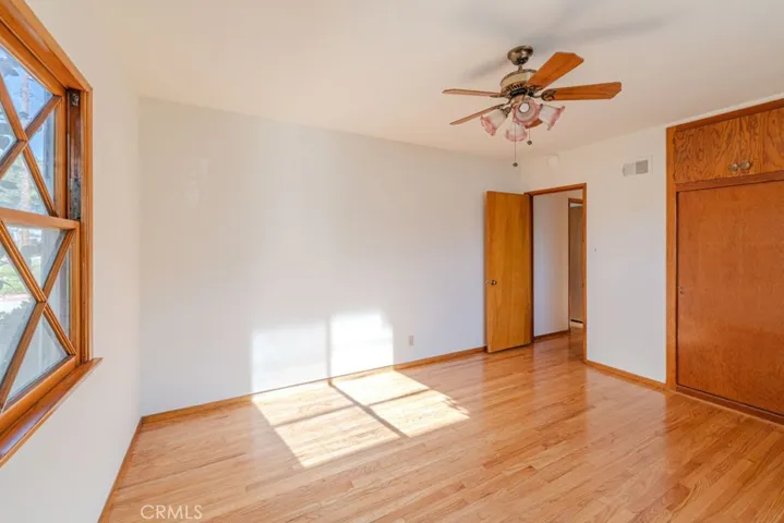 Bedroom 1 with ceiling fan and lots of light