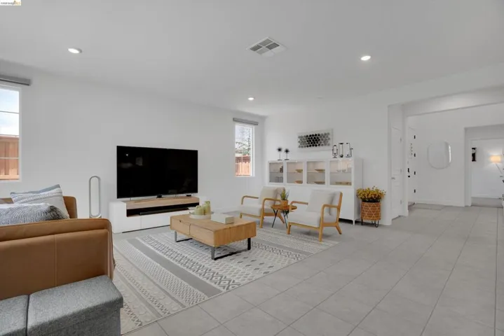 Living area featuring light tile patterned flooring and recessed lighting