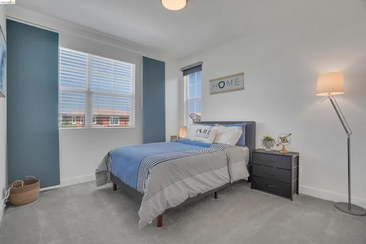 Bedroom featuring light colored carpet