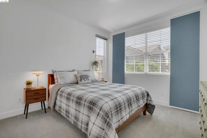 Bedroom with baseboards and light colored carpet