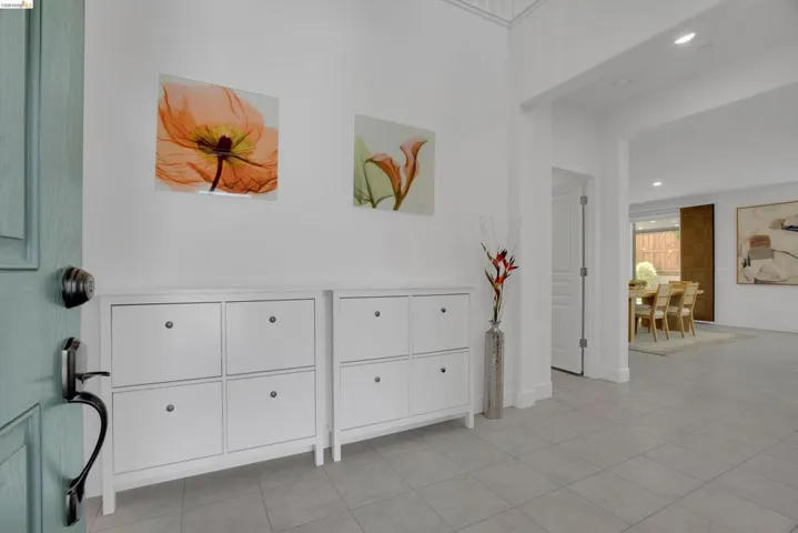 Hallway featuring recessed lighting and light tile patterned flooring