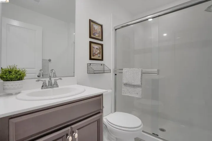 Full bathroom with vanity and a stall shower