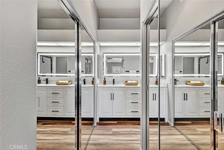 Two mirrored closets in primary bedroom.