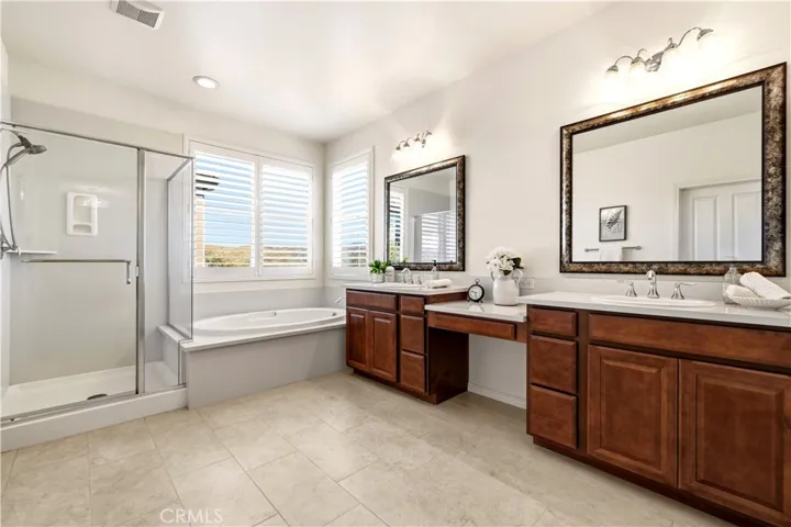 primary bathroom with dual sinks and vanity
