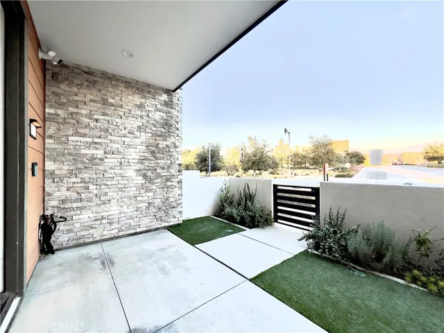 Private front patio with artificial grass and CA friendly plants