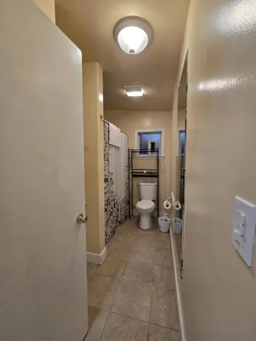 bathroom with tub and shower over tub