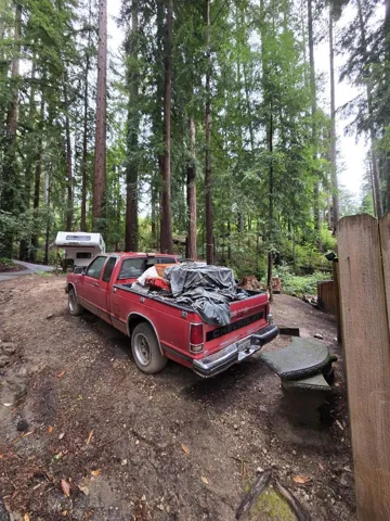 This land is part of the sale, including the parking spot of the traven trailer, red truck and sheds