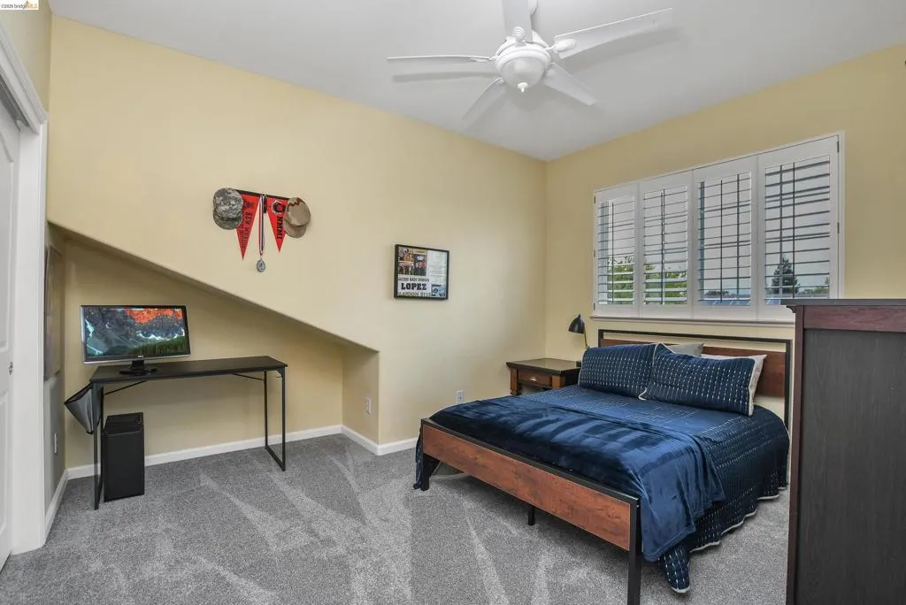 Bedroom featuring carpet flooring and ceiling fan