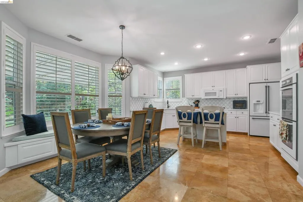 Dining area with hanging lights and baseboards
