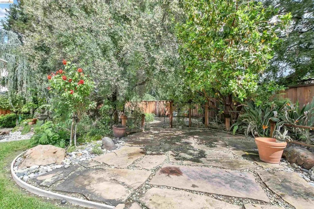 Fenced backyard with a patio