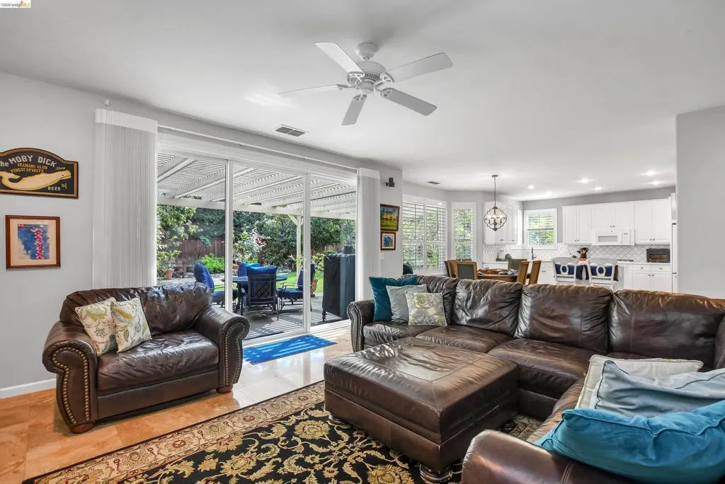 Living area with ceiling fan and hanging lights