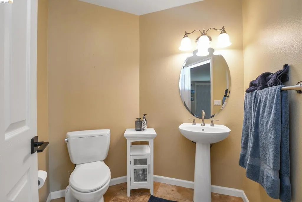 Half bath with toilet and baseboards