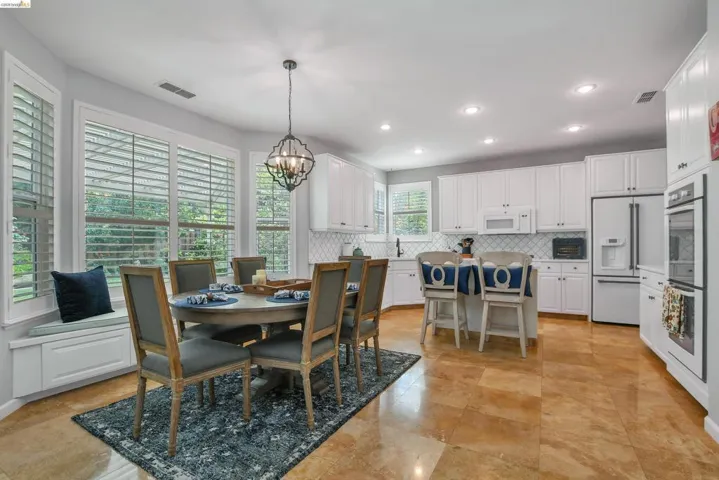 Dining area with hanging lights and baseboards