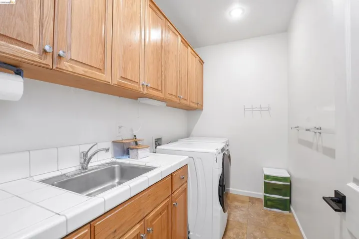 Laundry area with cabinet space and washing machine and dryer