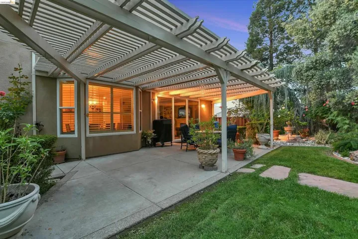 Patio terrace at dusk with a patio area and a pergola