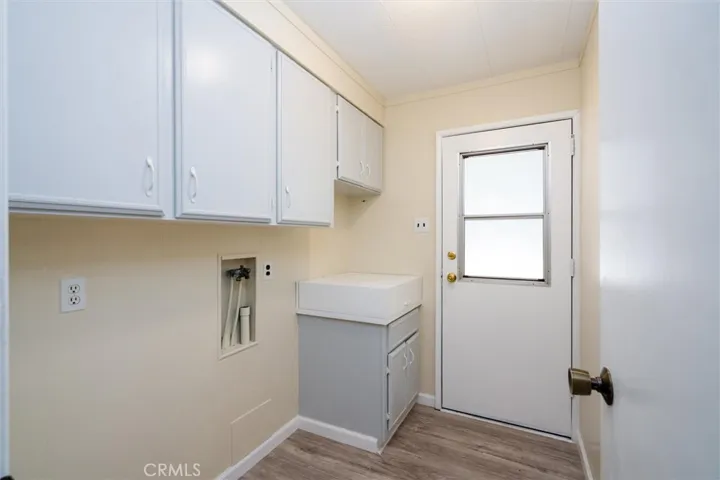 LAUNDRY ROOM WITH A DEEP SINK & STORAGE