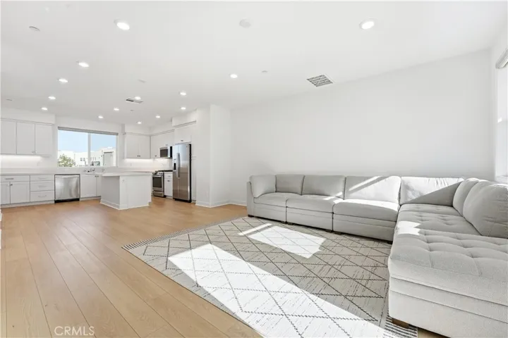 LARGE LIVING ROOM WITH PLENTY OF SUNSHINE.