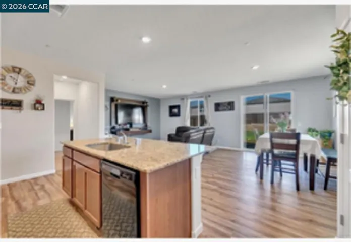 Photo shows view from Kitchen with open Dining and Living room area. Photo taken in 2021.
