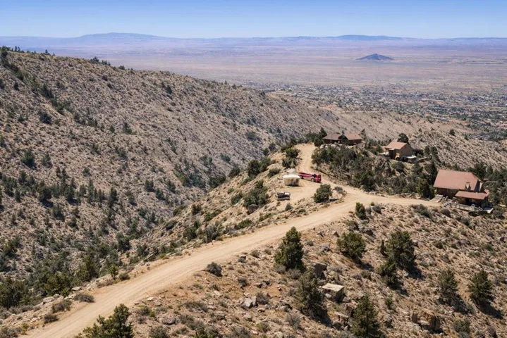 Winding road through desert hillside lan