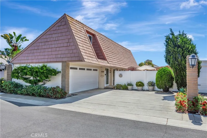 Two car garage with driveway ample for guests, offering space for two cars parked out front.