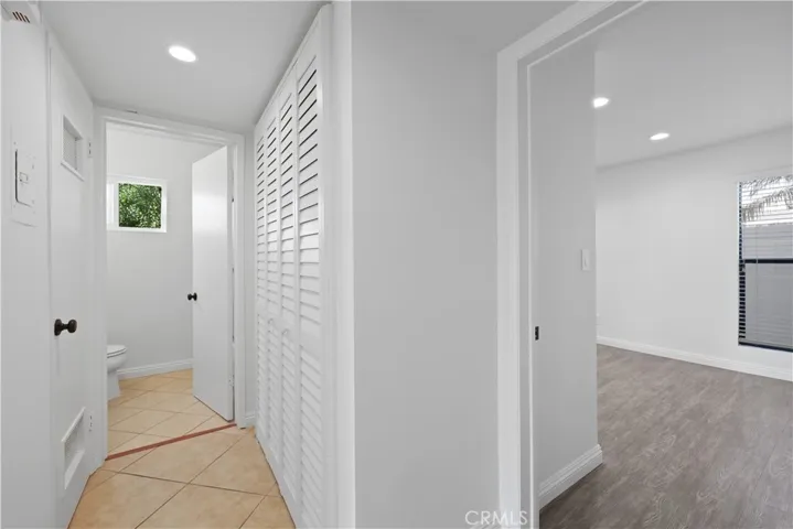 Hallway to secondary bath and laundry in closet