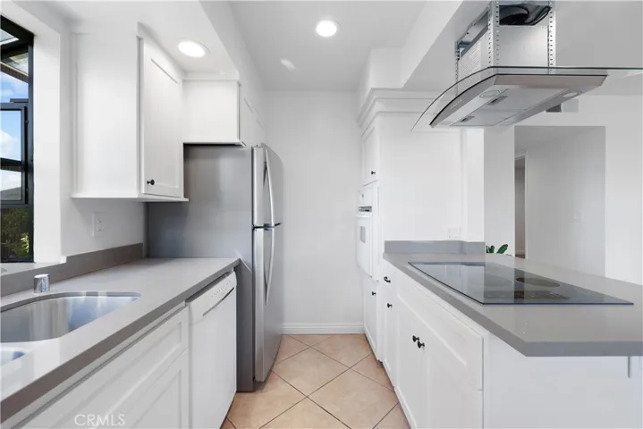 Kitchen with new cabinets and stainless steel refrigerator