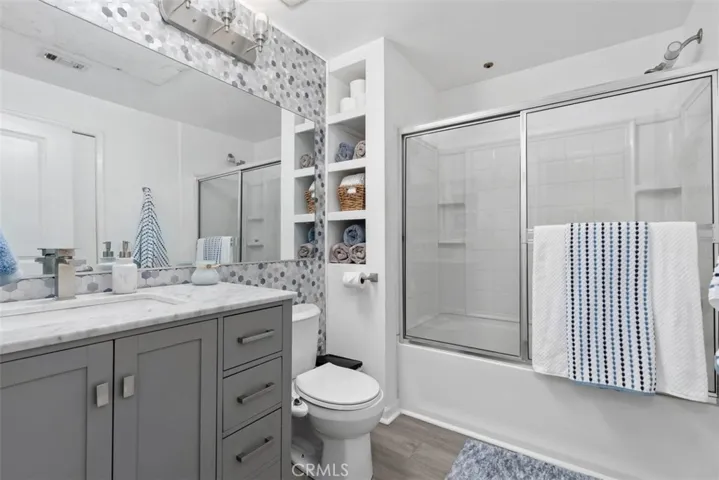 Upgraded bathroom with custom vanity and feature wall