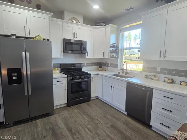 View of kitchen with refrigerator included.