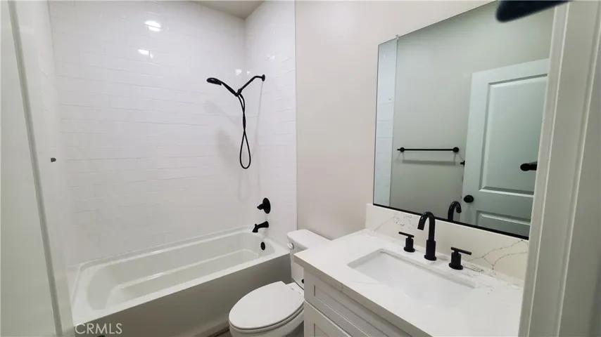 View of guest bathroom with shower/tub combo.