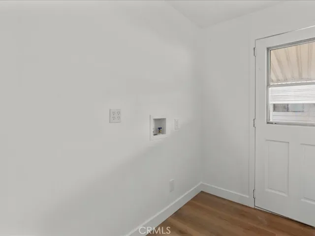 Washer & Dryer room by back door & Side patio and walkway