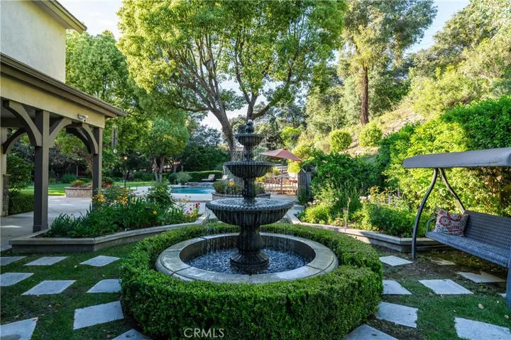 beautiful fountain and porch area out kitchen bay windows