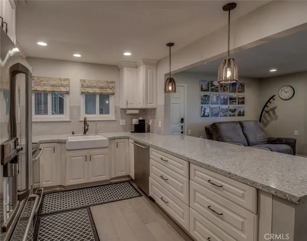 Kitchen. Note the custom cabinetry, canned lighting, and vinyl flooring, along with custom counter tops