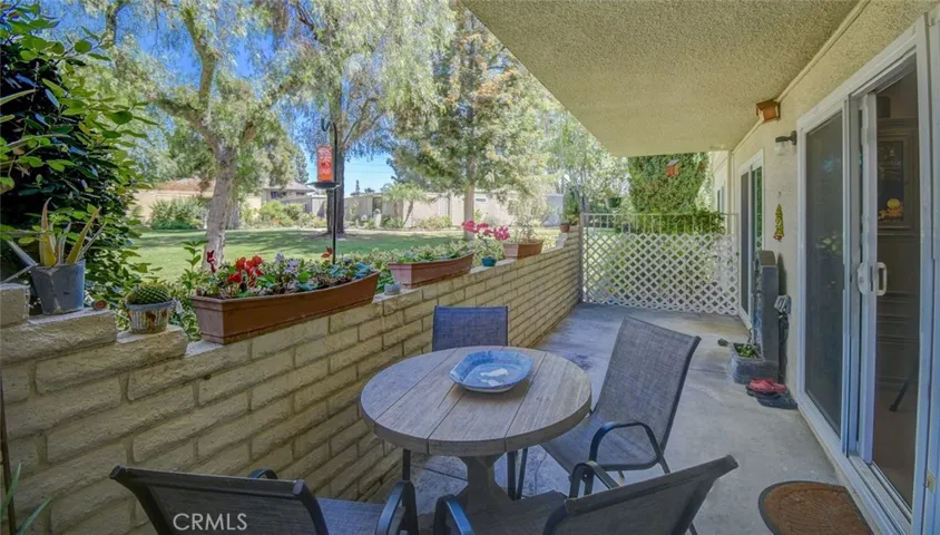 Patio from other end showing expansive green belt/tree views