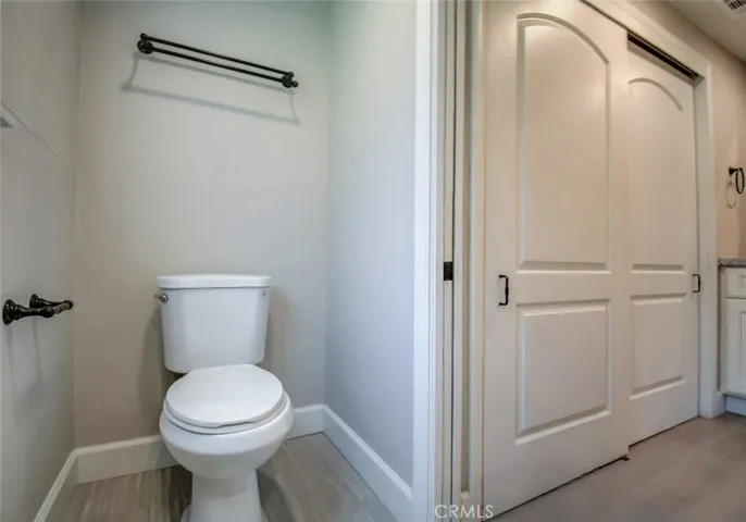 Upgraded commode in master, with "pocket door". Laundry is behind the first sliding door