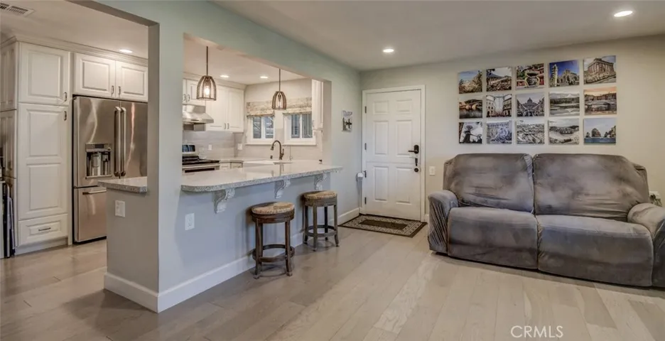 Entryway into living area and kitchen. Light and bright!