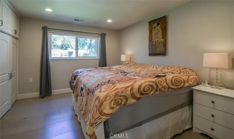 Master bedroom. Note the custom cabinetry/closets, vinyl flooring, vinyl windows and canned lighting. Central air throughout the unit