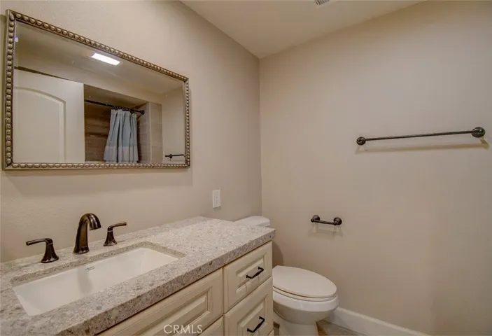 Second bath with granite vanity and custom mirrors