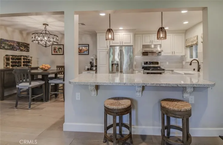 Kitchen with bar seats and adjacent dining area
