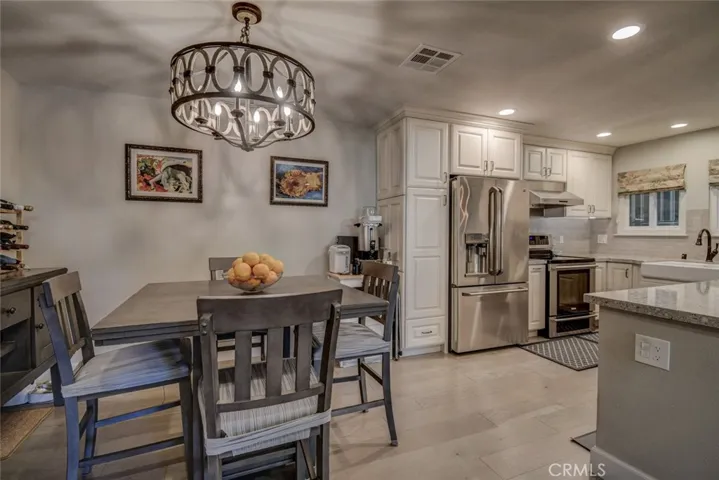 Nice dining area with custom lighting and easy access to kitchen and adjacent living area. Nice "great room" effect