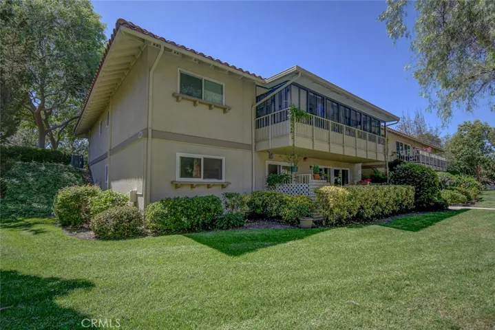 View from outside with wide green belt and mature landscaping