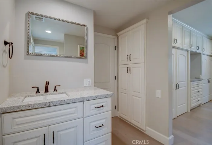 Master sink, storage, closets and door to room