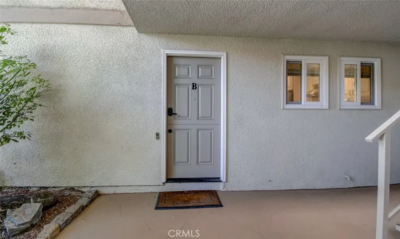 Front door with adjacent stairway for easy access either by foot or stairs