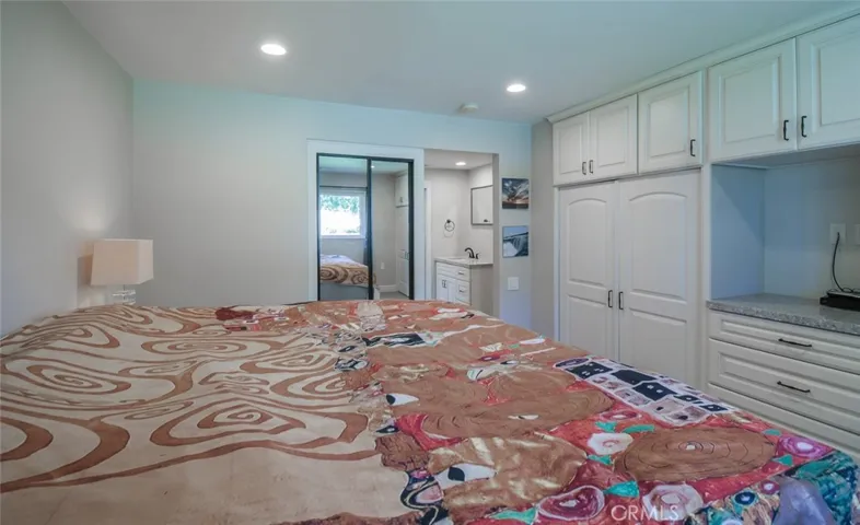 Master bedroom with custom cabinetry and shelving