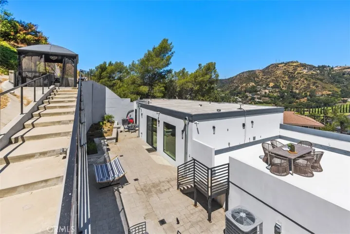 a "Senorita" style stairwell leads to elevated patio area.